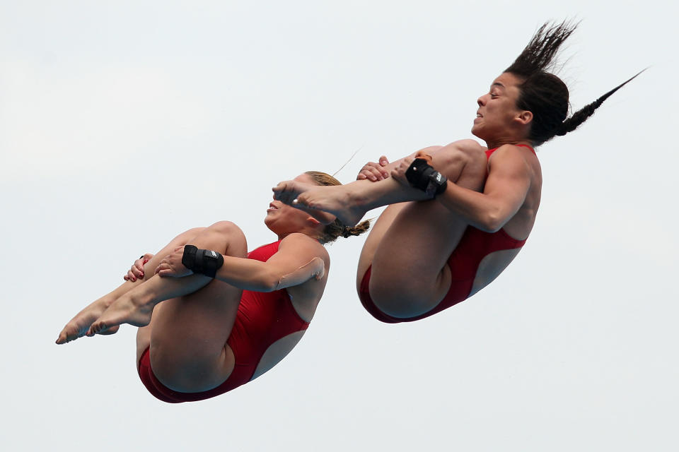 SHANGHAI, CHINA - JULY 18: Meaghan Benfeito and Roseline Filion of Canada compete in the Women's 10m Platform Synchro preliminary round during Day Three of the 14th FINA World Championships at the Oriental Sports Center on July 18, 2011 in Shanghai, China. (Photo by Zhang Lintao/Getty Images)