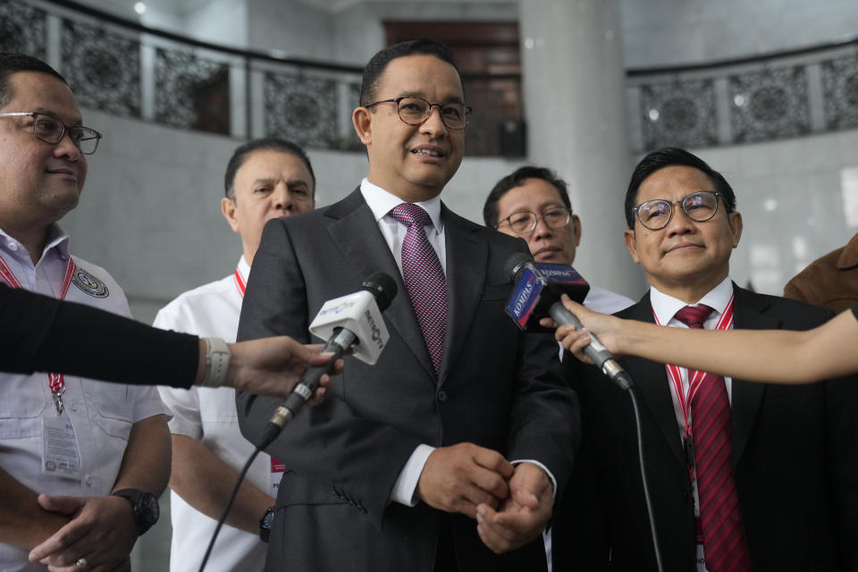 Losing presidential candidate Anies Baswedan, left, and his running mate Muhaimin Iskandar speak to the media upon arrival for the first hearing of their legal challenge to the Feb. 14 presidential election alleging widespread fraud, at the Constitutional Court in Jakarta, Indonesia, Wednesday, March 27, 2024. Defense Minister Prabowo Subianto, who chose the son of the popular outgoing President Joko Widodo as his running mate, won the election by 58.6% of the votes, according to final results released by the Election Commission. (AP Photo/Dita Alangkara)