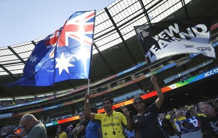 Supporters wave flags before the start of the Cricket World Cup final match between Australia and New Zealand at the Melbourne Cricket Ground (MCG) March 29, 2015. REUTERS/Jason Reed