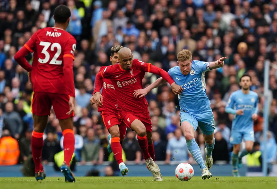 Liverpool&#39;s Fabinho (centre) and Manchester City&#39;s Kevin De Bruyne battle for the ball during the Premier League match at the Etihad Stadium, Manchester. Picture date: Sunday April 10, 2022. (Photo by Martin Rickett/PA Images via Getty Images)