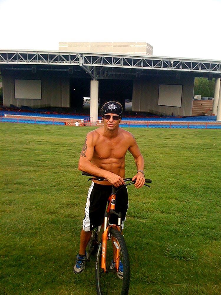 Bret Michaels rides his mountain bike prior to soundcheck at PNC Music Pavilion Amphitheater in Charlotte, N.C.