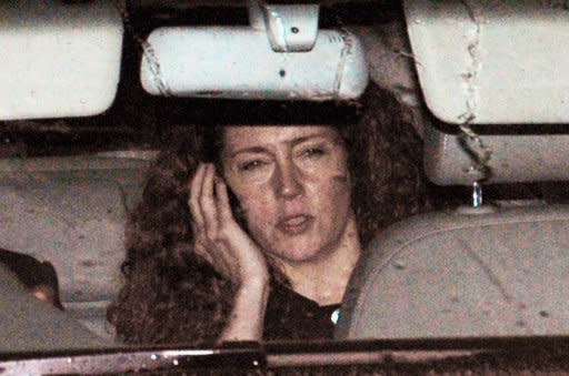 Former News International chief executive Rebekah Brooks leaves the Houses of Parliament in London last July after giving evidence to a parliamentary select committee on the phone hacking scandal. British Prime Minister David Cameron signed texts Brooks "lots of love" and privately discussed the News of the World scandal with her, she told an inquiry Friday