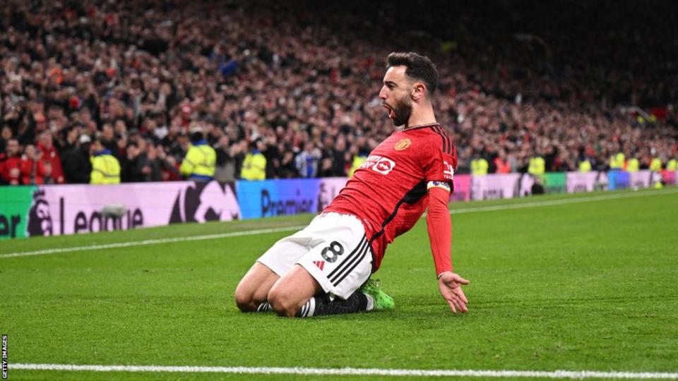 Bruno Fernandes slides on his knees at the corner flag to celebrate his second goal v Sheffield United