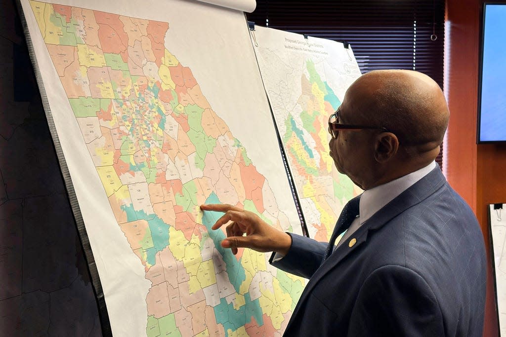 FILE - Georgia Rep. Mack Jackson, D-Sandersville, looks at a map of proposed state House districts before a House hearing, Nov. 29, 2023, at the state Capitol in Atlanta. On Tuesday, Dec. 12, plaintiffs who successfully sued to overturn Georgia's legislative and congressional districts asked a federal judge to reject Georgia's new Republican-backed maps. (AP Photo/Jeff Amy, File)