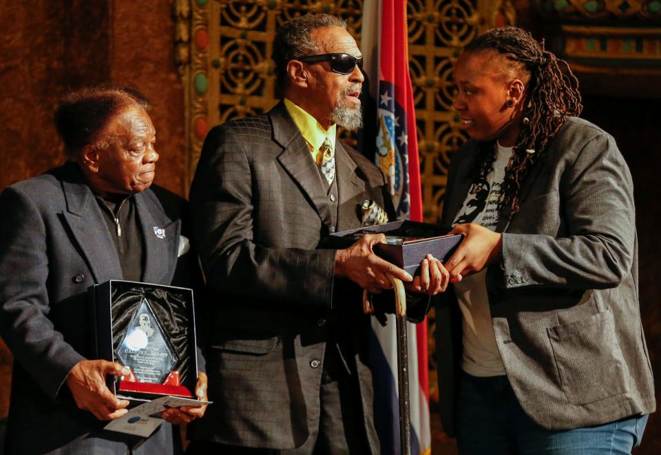 Toni Robinson, president of the Springfield branch of the NAACP, right, presents a plaque to Denny Whayne, center, and Calvin Allen, left, during the program for Martin Luther King Jr. Day at the Gillioz Theatre on Monday, Jan. 20, 2020.