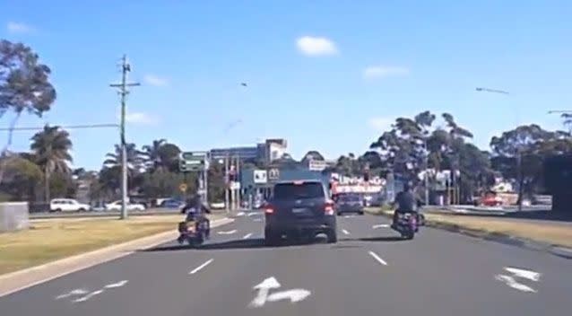 The riders are shown riding up on either side of the Toyota 4WD. Photo: Dash Cam Owners Australia