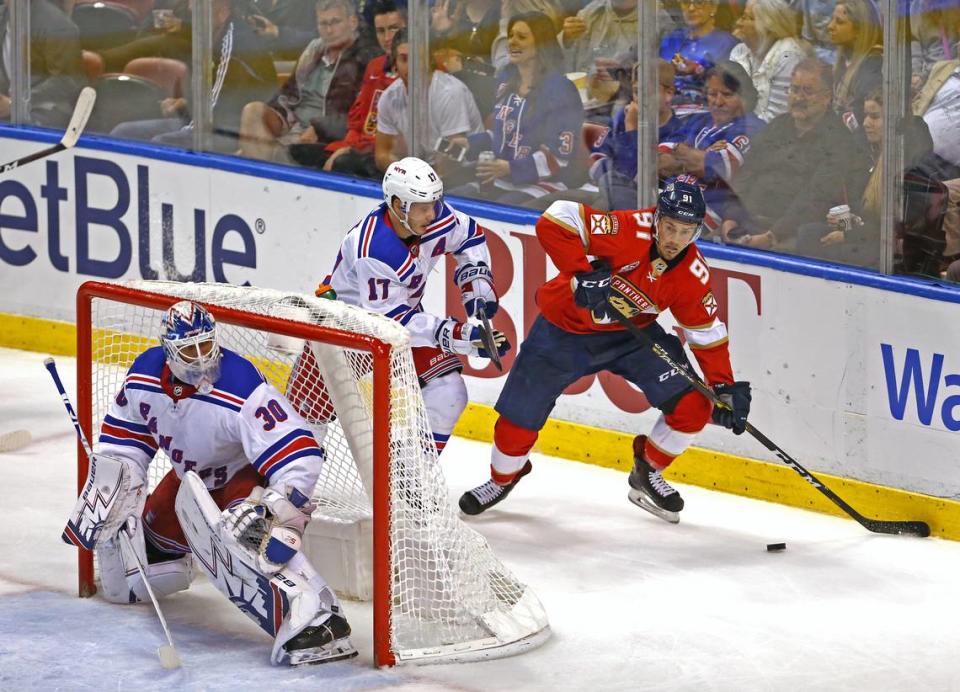 Florida Panthers left wing Juho Lammikko #91 carries the puck against New York Rangers right wing Jesper Fast #17 and goalie Henrik Lundqvist #30 during the second period of an NHL regular season hockey game at the BB&T Center on Saturday, December 8, 2018 in Sunrise.