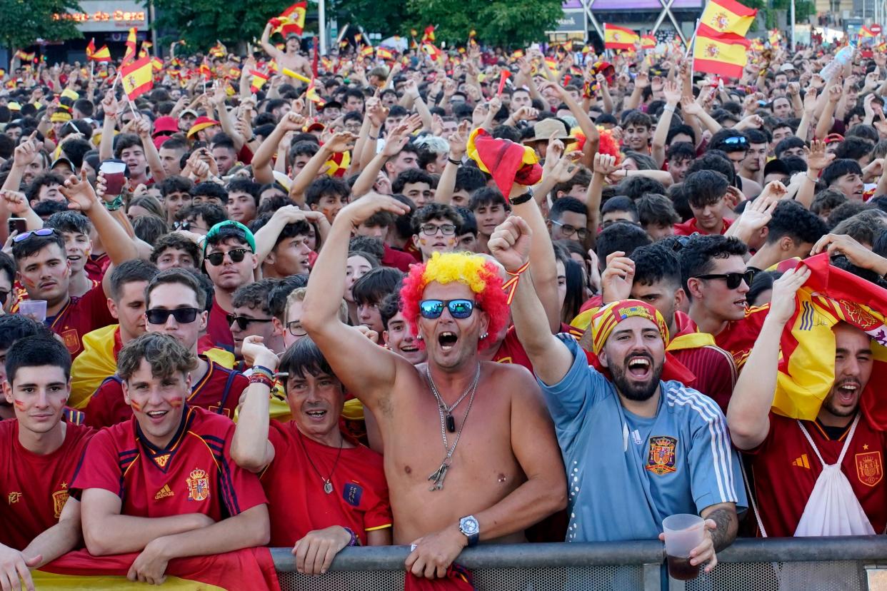 Spanish fans in Madrid cheer their team (AP)