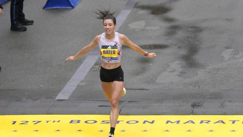 Emma Bates, of Minnesota, crosses the finish line of the Boston Marathon, Monday, April 17, 2023, in Boston. Bates was the top American woman finisher.
