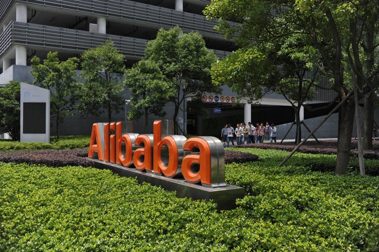 Chinese workers walk out of the Alibaba head office building in Hangzhou, in eastern China's Zhejiang province on May 21, 2012. As Alibaba chief Jack Ma steps aside after building the world's largest online retailer, the Chinese firm is preparing a huge stock offer prompting comparisons with Facebook -- whose profits it dwarfs