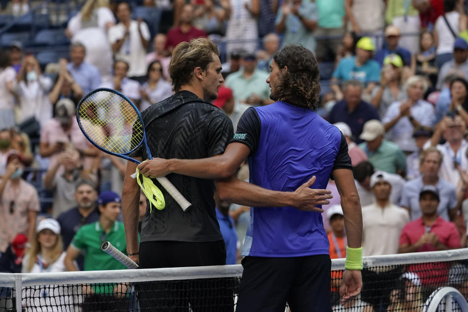 Alexander Zverev, of Germany, left, greets Lloyd Harris, of South Africa, at the net after defeating Harris during the quarterfinals of the US Open tennis championships, Wednesday, Sept. 8, 2021, in New York. (AP Photo/Elise Amendola)