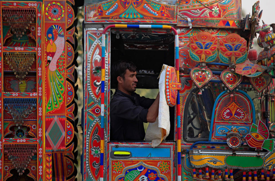 A man cleans his truck in Charsadda, Pakistan