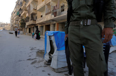 A Kurdish fighter of the Asayish security force stands at a checkpoint in Aleppo's Sheikh Maqsoud neighbourhood, Syria July 15, 2017. REUTERS/Omar Sanadiki