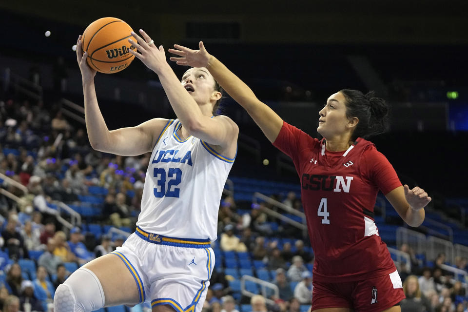 UCLA forward Angela Dugalic, left, shoots as Cal State Northridge guard Rachel Harvey defends during the first half of an NCAA college basketball game Thursday, Dec. 7, 2023, in Los Angeles. (AP Photo/Mark J. Terrill)