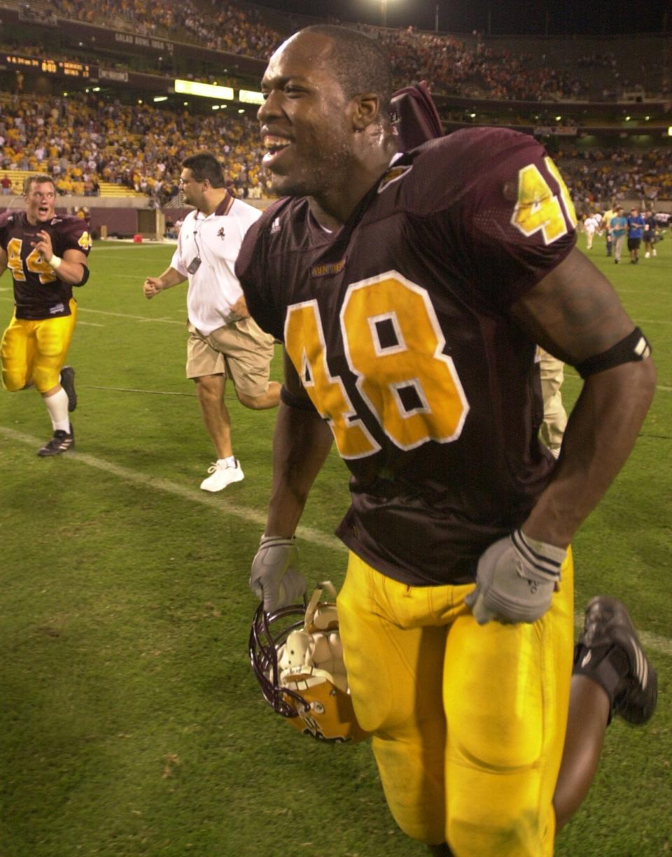 Arizona State's Terrell Suggs wears a big smile as he runs off the field after beating  Oregon St. during PAC-10 action at Sun Devil Stadium in Tempe Saturday night. Oct. 2, 2002