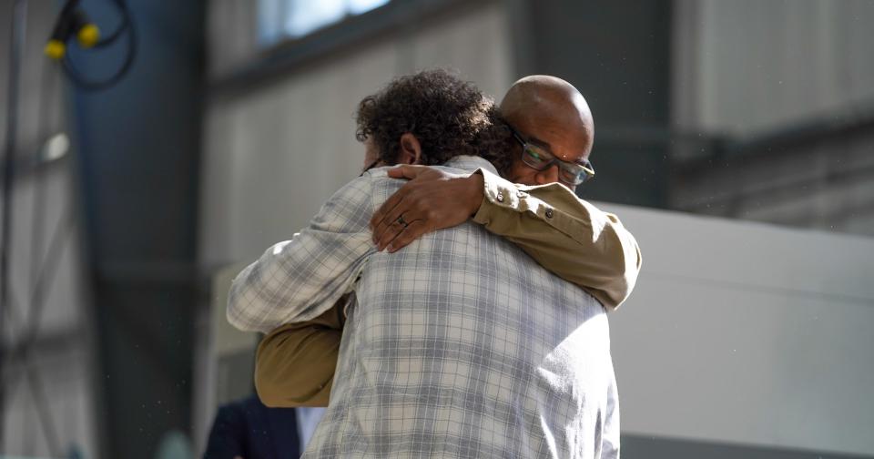 JEMS by Pensole founder D’Wayne Edwards and the company’s director of manufacturing Scot Hull embrace during the opening of the new factory in Somersworth, N.H.