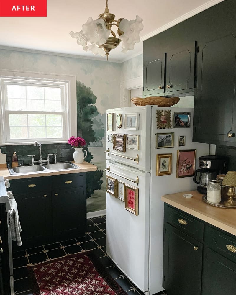 Mural painted on wall near kitchen sink in newly renovated kitchen with dark painted cabinets.