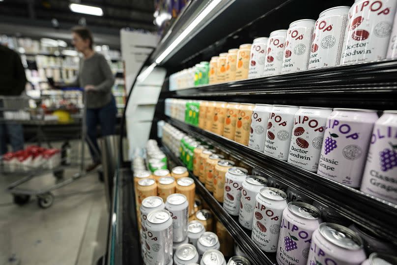 Cans of Olipop, a drink containing botanicals, plant fibers, and prebiotics, displayed at a supermarket in the US.