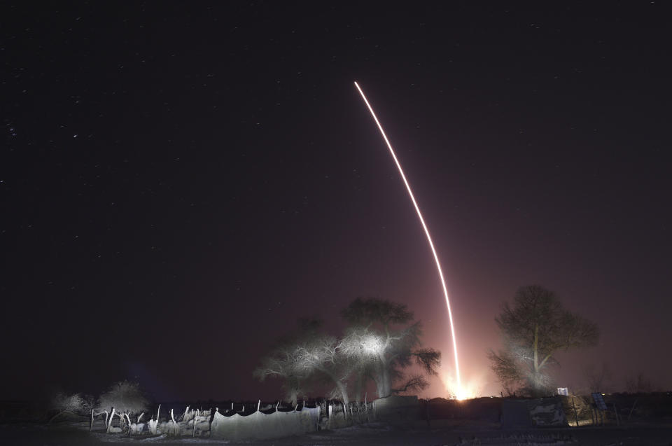 In this photo released by Xinhua News Agency, the light trail of the launched manned spaceship Shenzhou-15, atop the Long March-2F Y15 carrier rocket after it blasted off from the Jiuquan Satellite Launch Center in northwestern China on Tuesday, Nov. 29, 2022. China launched the rocket Tuesday carrying three astronauts to complete construction of the country's permanent orbiting space station. (Ren Junchuan/Xinhua via AP)