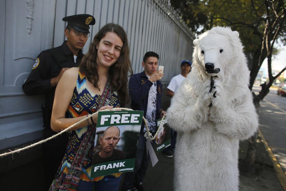 A Greenpeace activist in a polar bear suit acknowledges demonstrators outside the Russian embassy in Mexico City