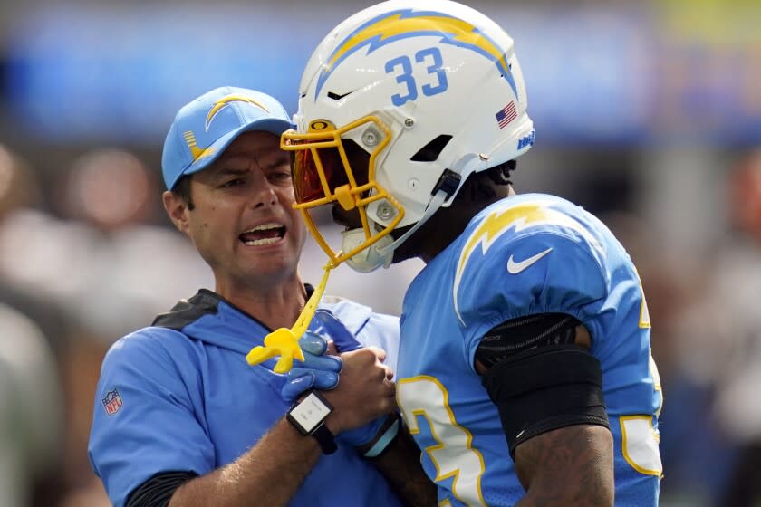 Los Angeles Chargers head coach Brandon Staley talks to free safety Derwin James (33).