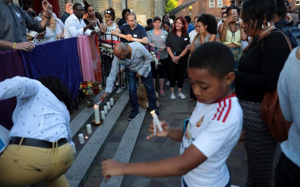 Prays are said and candles are lit outside Notting Hill Methodist Church near the 24 storey residential Grenfell Tower block in Latimer Road - Credit: Getty