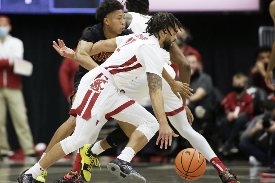 Washington State guard Michael Flowers, front, drives with the ball while pressured by Southern California guard Boogie Ellis during the first half of an NCAA college basketball game, Saturday, Dec. 4, 2021, in Pullman, Wash. (AP Photo/Young Kwak)