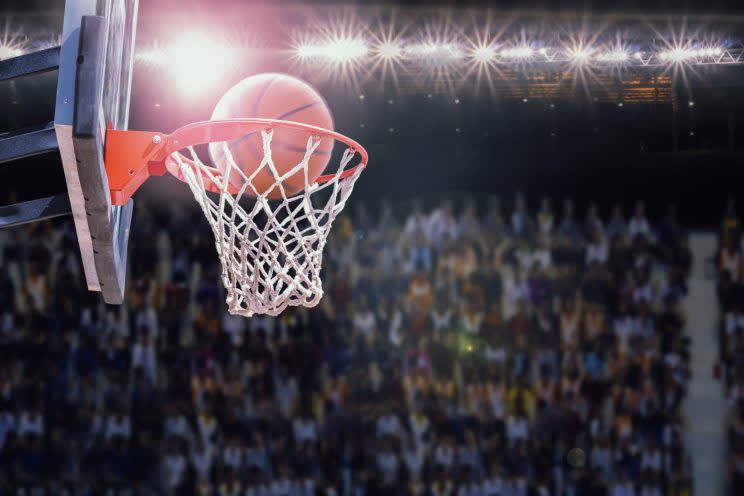 A woman won a half-court shot contest at a basketball game while her boyfriend was trying to propose. (Photo: Getty Images)