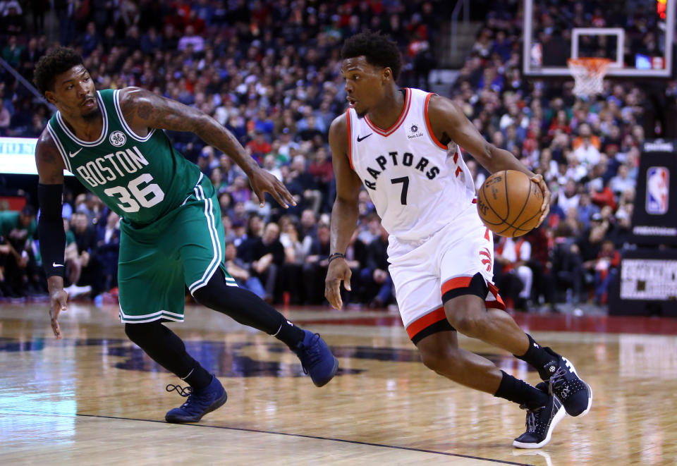 TORONTO, ON - FEBRUARY 26:  Kyle Lowry #7 of the Toronto Raptors dribbles the ball as Marcus Smart #36 of the Boston Celtics defends during the second half of an NBA game at Scotiabank Arena on February 26, 2019 in Toronto, Canada.  NOTE TO USER: User expressly acknowledges and agrees that, by downloading and or using this photograph, User is consenting to the terms and conditions of the Getty Images License Agreement.  (Photo by Vaughn Ridley/Getty Images)