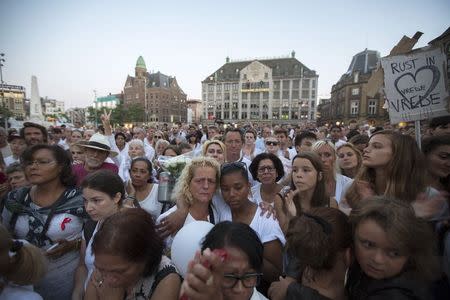 People pay their respects during a national day of mourning for the victims killed in Malaysia Airlines Flight MH17 plane disaster, in Amsterdam in this July 23, 2014 file photo. REUTERS/Cris Toala Olivares/Files