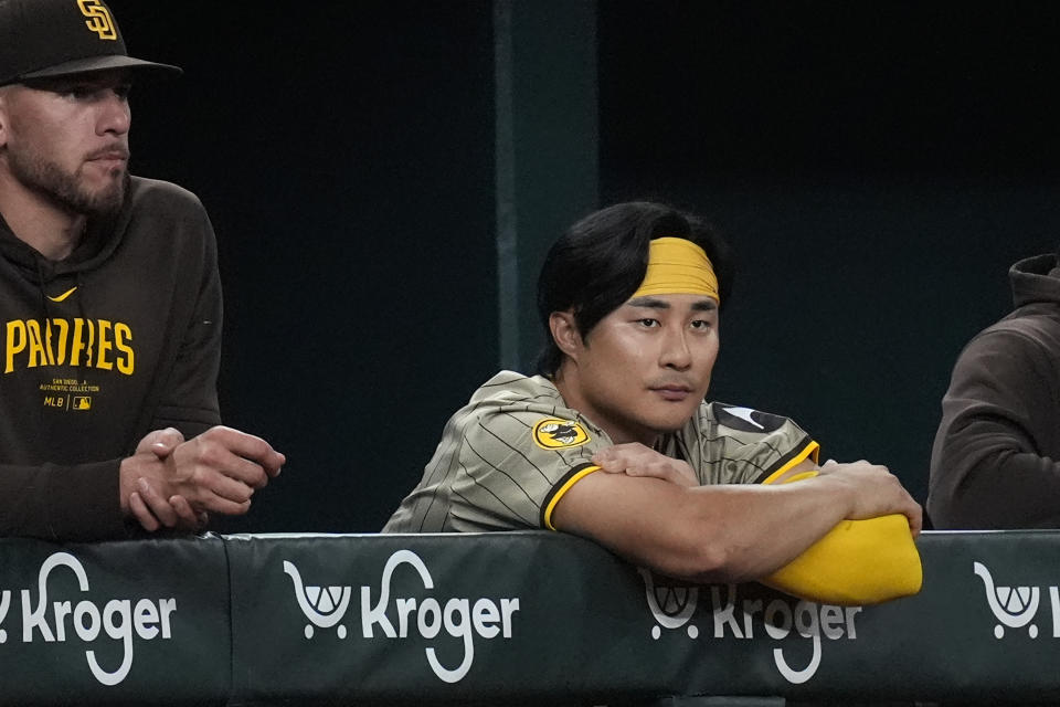 San Diego Padres shortstop Ha-Seong Kim, right, of South Korea, watches from the dugout with teammate Joe Musgrove during the ninth inning of a baseball game against the Texas Rangers in Arlington, Texas, Tuesday, July 2, 2024. (AP Photo/LM Otero)