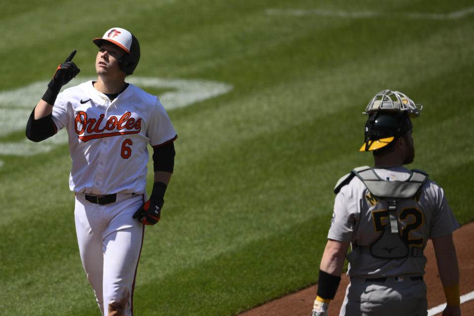 Baltimore Orioles' Ryan Mountcastle (6) celebrates afterhis two-run home run next to Oakland Athletics catcher Kyle McCann (52) during the third inning of a baseball game, Sunday, April 28, 2024, in Baltimore. (AP Photo/Nick Wass)