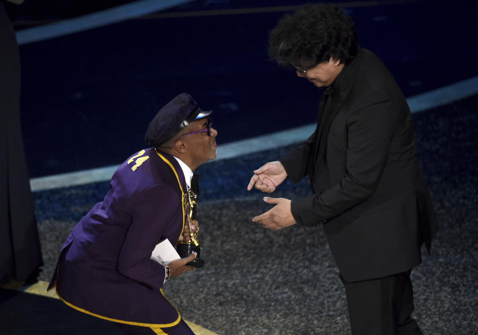 Spike Lee, left, presents the award for best director to Bong Joon Ho for "Parasite" at the Oscars on Sunday, Feb. 9, 2020, at the Dolby Theatre in Los Angeles. (AP Photo/Chris Pizzello)