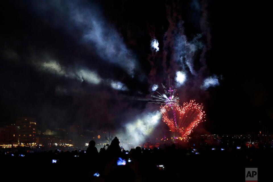 <p>Fireworks detonate as people kiss on the Old Port of Marseille, southern France, to mark Valentine’s Day. The event is part of a Love Festival which starts this Tuesday in Marseille. (AP Photo/Claude Paris) </p>