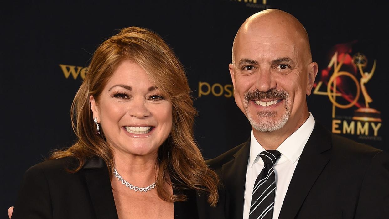 Valerie Bertinelli smiles with Tom Vitale in a striped tie at the Daytime Emmy AwardValerie Bertinelli smiles with Tom Vitale in a striped tie at the Daytime Emmy Awards in 2019s in 2019