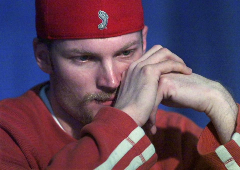 FILE - Driver Dale Earnhardt Jr., sits quietly during a news conference at the North Carolina Speedway, near Rockingham, N.C., Friday, Feb. 23, 2001, as he listens to fellow driver Michael Waltrip talk about his father, Dale Sr., who was killed the Sunday before on the last lap of the Daytona 500. As he prepares to join his late father in the NASCAR Hall of Fame, Dale Earnhardt Jr. can't help but wonder what his Dad would make of the career he's built on and off the track. (AP Photo/Gerry Broome, File)