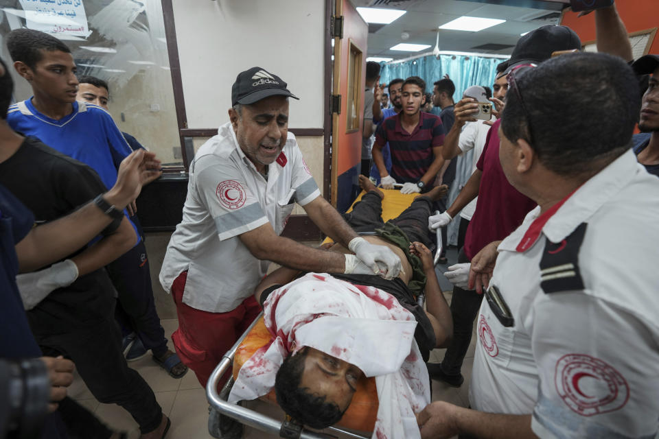 Palestinians wounded in the Israeli bombardment of the Gaza Strip are brought to Al Aqsa hospital in Deir al Balah, Gaza Strip, Tuesday, Thursday, May 23, 2024. (AP Photo/Abdel Kareem Hana)