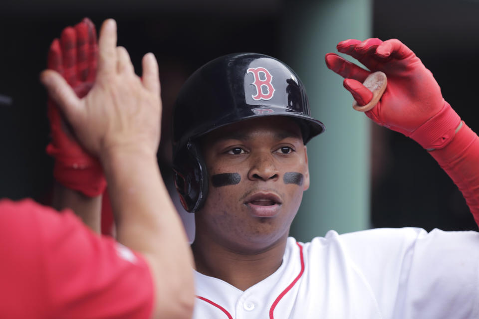 Boston Red Sox's Rafael Devers is congratulated by teammates after his three-run home run during the fifth inning of a baseball game against the Toronto Blue Jays at Fenway Park in Boston, Thursday, July 18, 2019. (AP Photo/Charles Krupa)