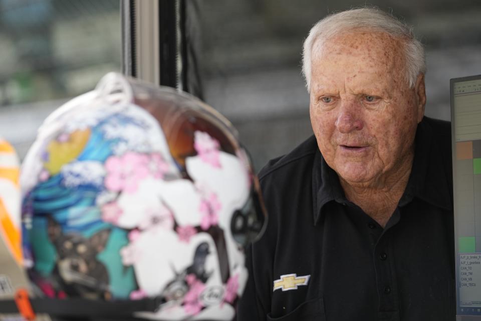 A. J. Foyt, right, talks with Santino Ferrucci during practice for the IndyCar Grand Prix auto race at Indianapolis Motor Speedway, Friday, May 12, 2023, in Indianapolis. (AP Photo/Darron Cummings)