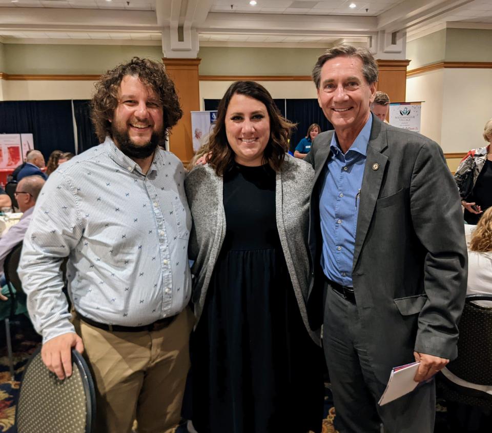 Alec and Carla Donahue, two recent Muncie residents who came to the city through the Make My Move program, pose with Muncie Mayor Dan Ridenour at a recent Muncie on the Move breakfast.