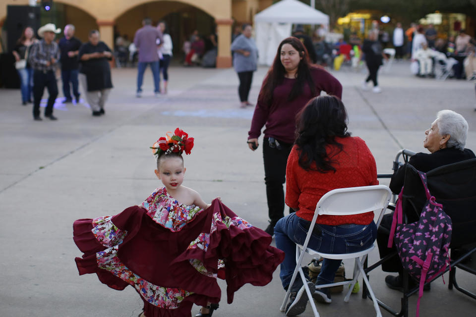 In this Feb. 8, 2020, photo, people gather during the celebration of the town's 45th year since it was incorporated, in Guadalupe, Ariz. Today, nearly a third of Guadalupe's 6,500 residents say they are Native American and about 75% of all races identify as Hispanic. Small, poor and largely Latino communities like these around the U.S. historically have been undercounted, an analysis by The Associated Press shows, posing challenges for Census workers in a tally that's supposed to ensure federal dollars get to communities needing them most. (AP Photo/Dario Lopez-MIlls)