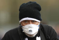 A Newcastle United fan wears a face mask in an attempt to protect himself from the coronavirus, outside the ground prior to the English Premier League soccer match between Southampton and Newcastle United, at St Mary's Stadium, Southampton, England, Saturday March 7, 2020. (Mark Kerton/PA via AP)