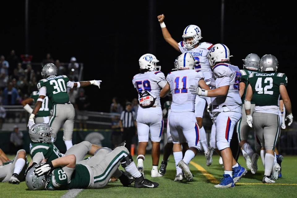 De La Salle’s Derek Thompson (62) reacts on the ground as Folsom quarterback Austin Mack (12) celebrates his two-yard touchdown run during the fourth quarter of their game at De La Salle High School in Concord on Friday, Sept. 23, 2022. Folsom defeated De La Salle 24-20.