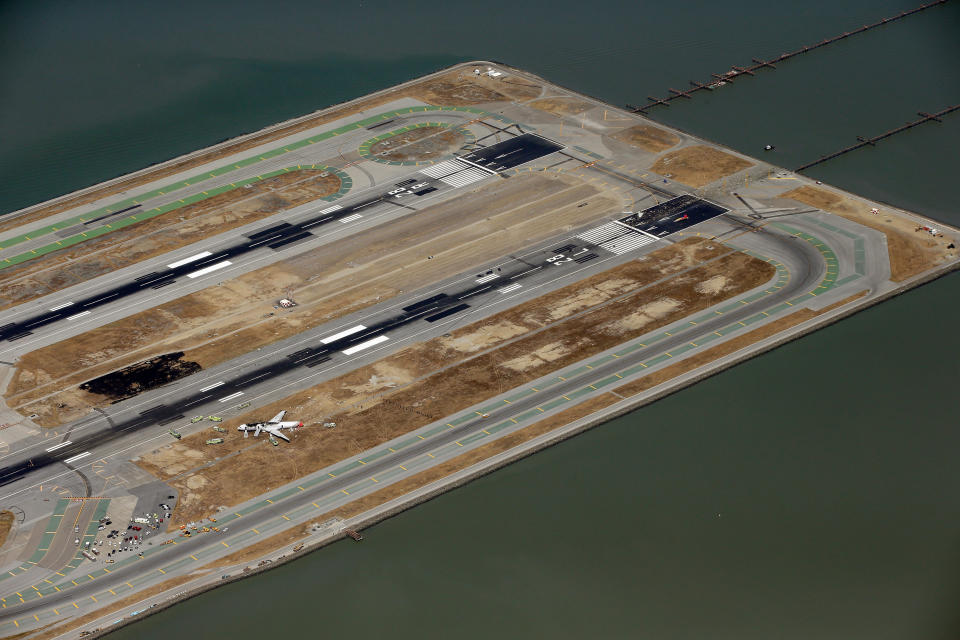 SAN FRANCISCO, CA - JULY 06:  A Boeing 777 airplane lies burned on the runway after it crash landed at San Francisco International Airport July 6, 2013 in San Francisco, California. An Asiana Airlines passenger aircraft coming from Seoul, South Korea crashed while landing. There has been at least two casualties reported. (Photo by Ezra Shaw/Getty Images)