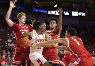 Nebraska's Derrick Walker (13) loses control of the ball against Wisconsin's Steven Crowl (22), Chucky Hepburn (23) and Jonathan Davis (1) during the first half of an NCAA college basketball game Thursday, Jan. 27, 2022, in Lincoln, Neb. (AP Photo/Rebecca S. Gratz)