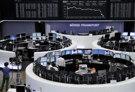Traders are pictured at their desks in front of the DAX board at the Frankfurt stock exchange July 25, 2014. REUTERS/Remote/Janine Eggert