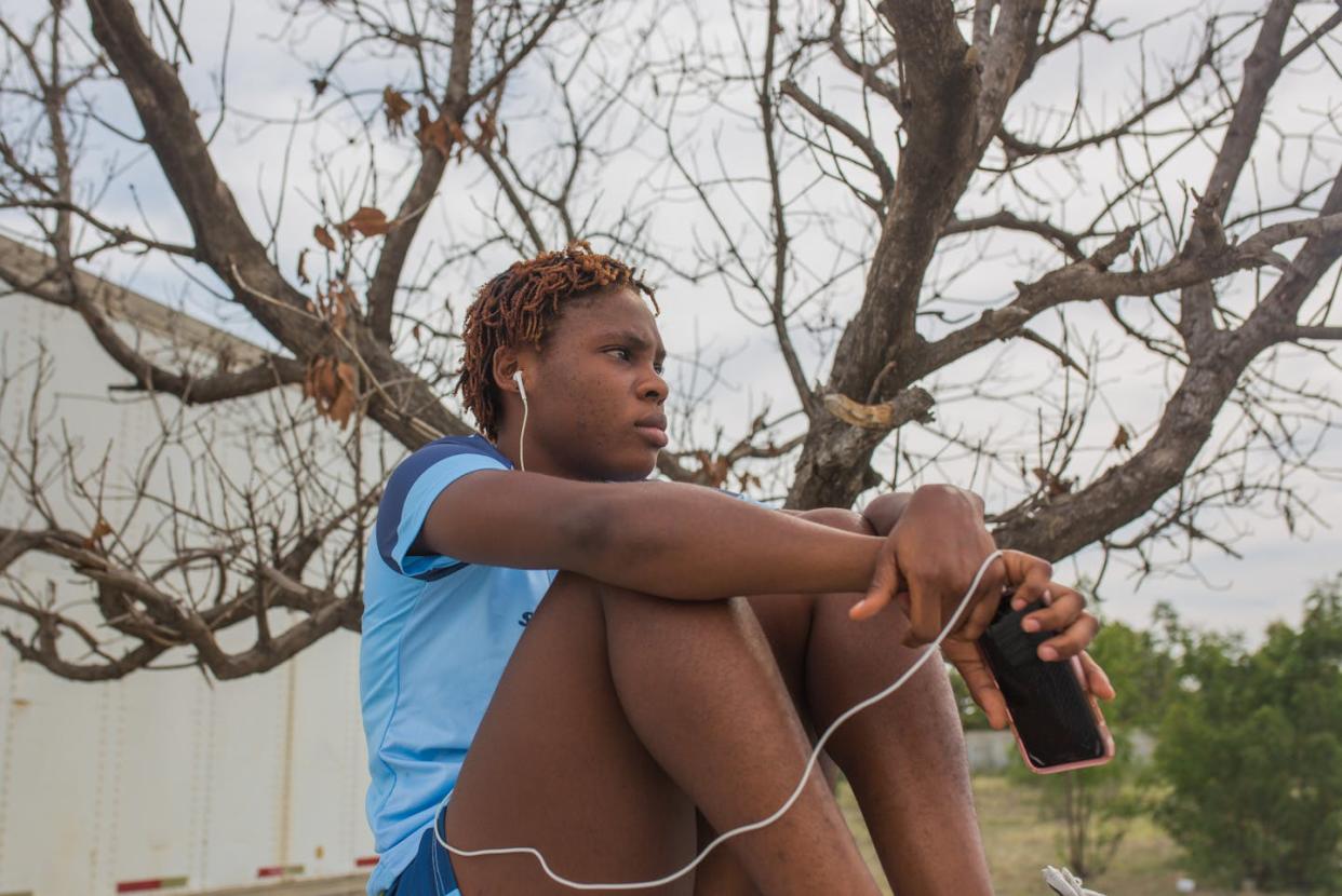 Listening to music from a device creates a protective bubble that can counteract a lack of personal space at school or home. <a href="https://www.gettyimages.com/detail/news-photo/physeline-michel-a-member-of-the-haitian-female-soccer-team-news-photo/1213010698?adppopup=true" rel="nofollow noopener" target="_blank" data-ylk="slk:Pierre Michel Jean/AFP via Getty Images;elm:context_link;itc:0;sec:content-canvas" class="link ">Pierre Michel Jean/AFP via Getty Images</a>