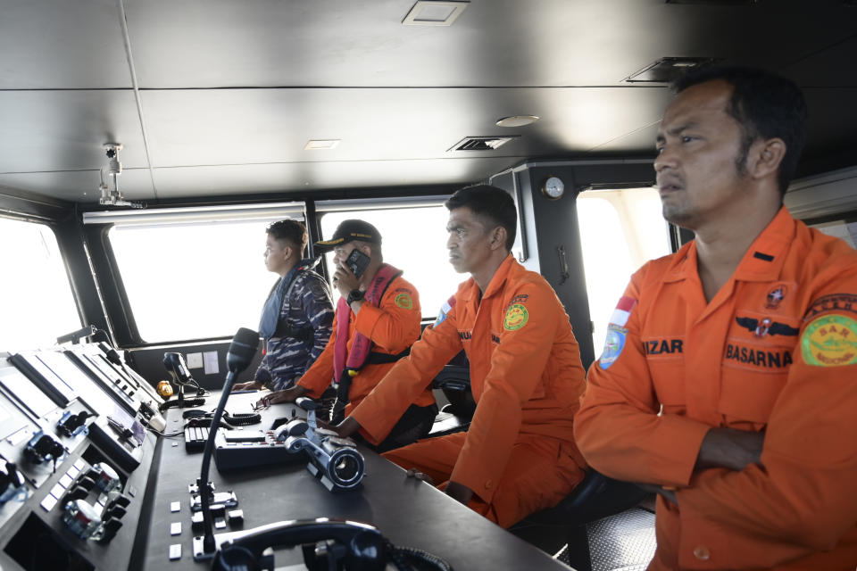 Members of the National Search and Rescue Agency scan the horizon during the search for a boat carrying Rohingya refugees reportedly capsized in the waters off West Aceh, Indonesia, Thursday, March 21, 2024. A wooden boat carrying dozens of Rohingya Muslims capsized off Indonesia's northernmost coast on Wednesday, according to local fishermen who rescued six people. (AP Photo/Reza Saifullah)