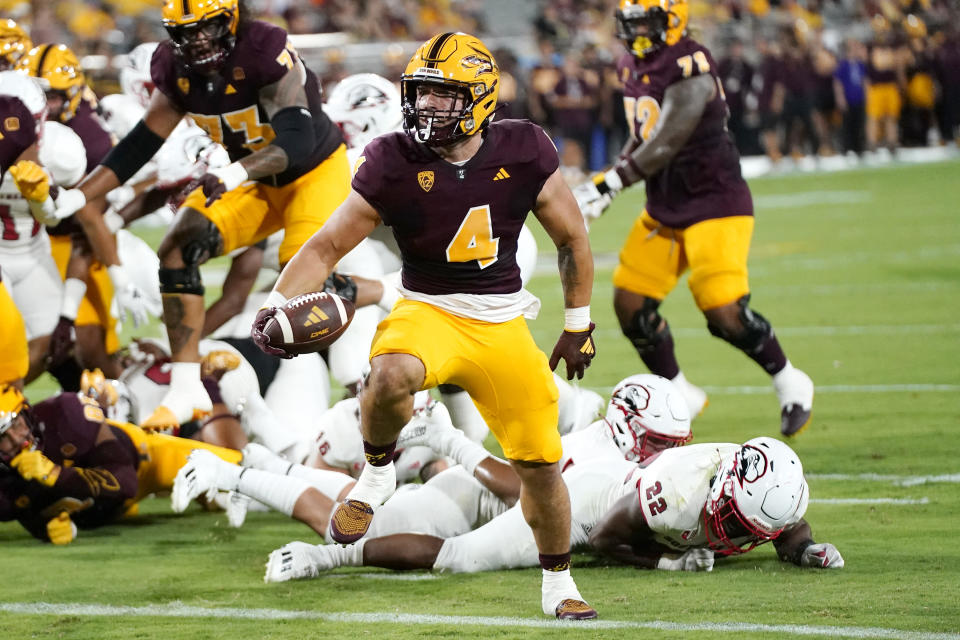 Arizona State running back Cameron Skattebo (4) scores a touchdown past Southern Utah linebacker Aubrey Nellems (22) during the first half of an NCAA college football game Thursday, Aug. 31, 2023, in Tempe, Ariz. (AP Photo/Ross D. Franklin)