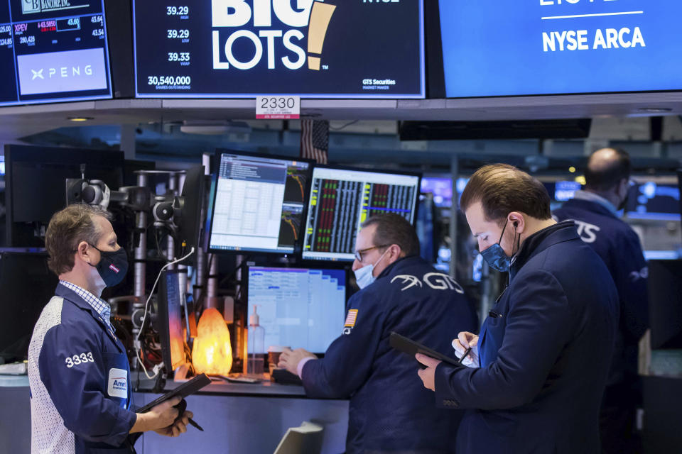 In this photo provided by the New York Stock Exchange, traders work on the floor, Friday, Jan. 21, 2022. Inflation fears and concerns about the impact of higher interest rates have prompted a cautious shift in the broader market after a solid year of gains in 2021. (Courtney Crow/New York Stock Exchange via AP)